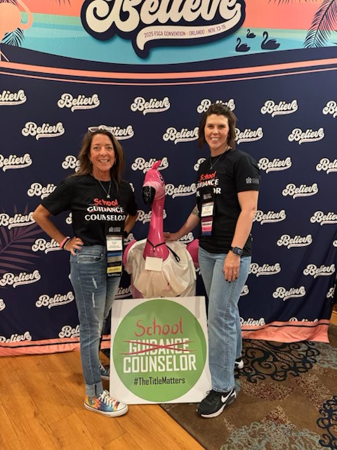 Lisa and Terina at a professional convention next to a flamingo mascot
